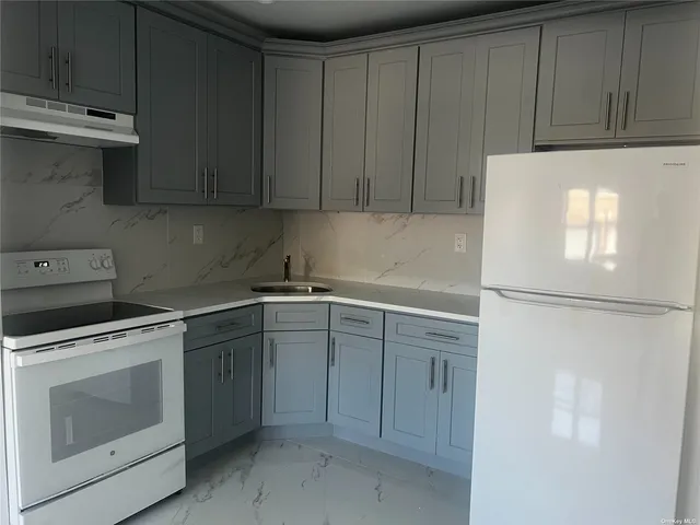a kitchen with a refrigerator sink stove and cabinets