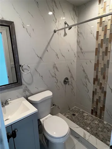 a white toilet sitting next to a bathroom sink