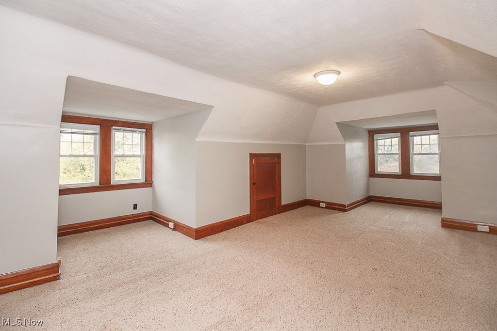 3085 Somerton Road Cleveland, OH 44118 - Photo 16 of 16 Bonus room featuring lofted ceiling, a healthy amount of sunlight, and baseboards