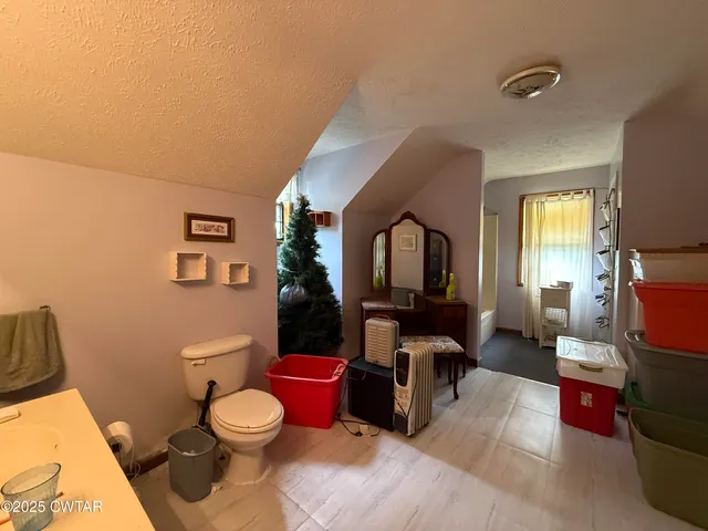 a backyard of a house with garden and swing