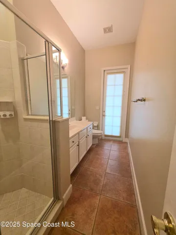 a bathroom with sink a mirror and a shower