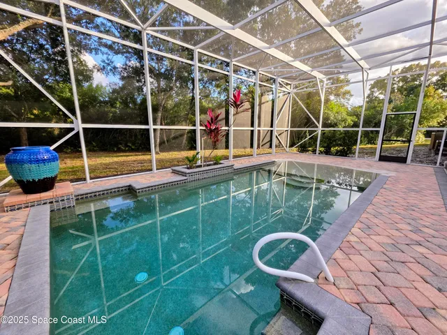 a view of a room with wooden floor and windows