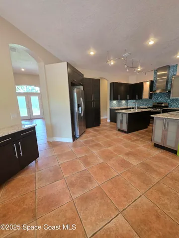 a kitchen with stainless steel appliances a refrigerator and a stove top oven