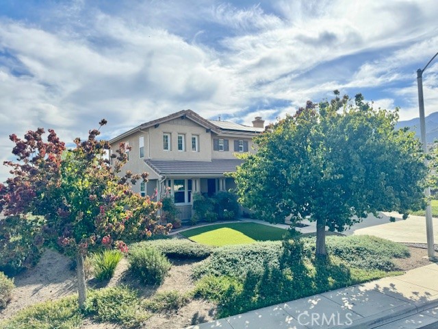a view of a house with swimming pool and a yard