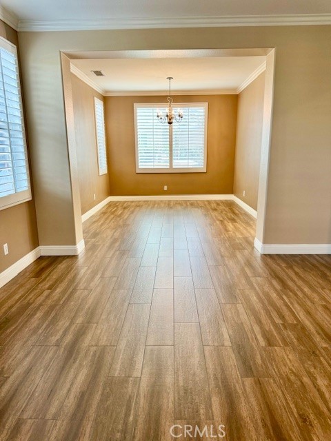 23636 Aquacate Road Corona, CA 92883 - Photo 12 of 74 an empty room with wooden floor and windows
