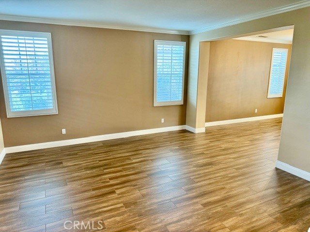 23636 Aquacate Road Corona, CA 92883 - Photo 9 of 74 an empty room with wooden floor and windows