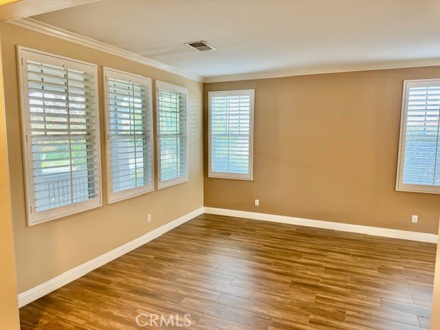 23636 Aquacate Road Corona, CA 92883 - Photo 10 of 74 a view of an empty room with wooden floor and a window