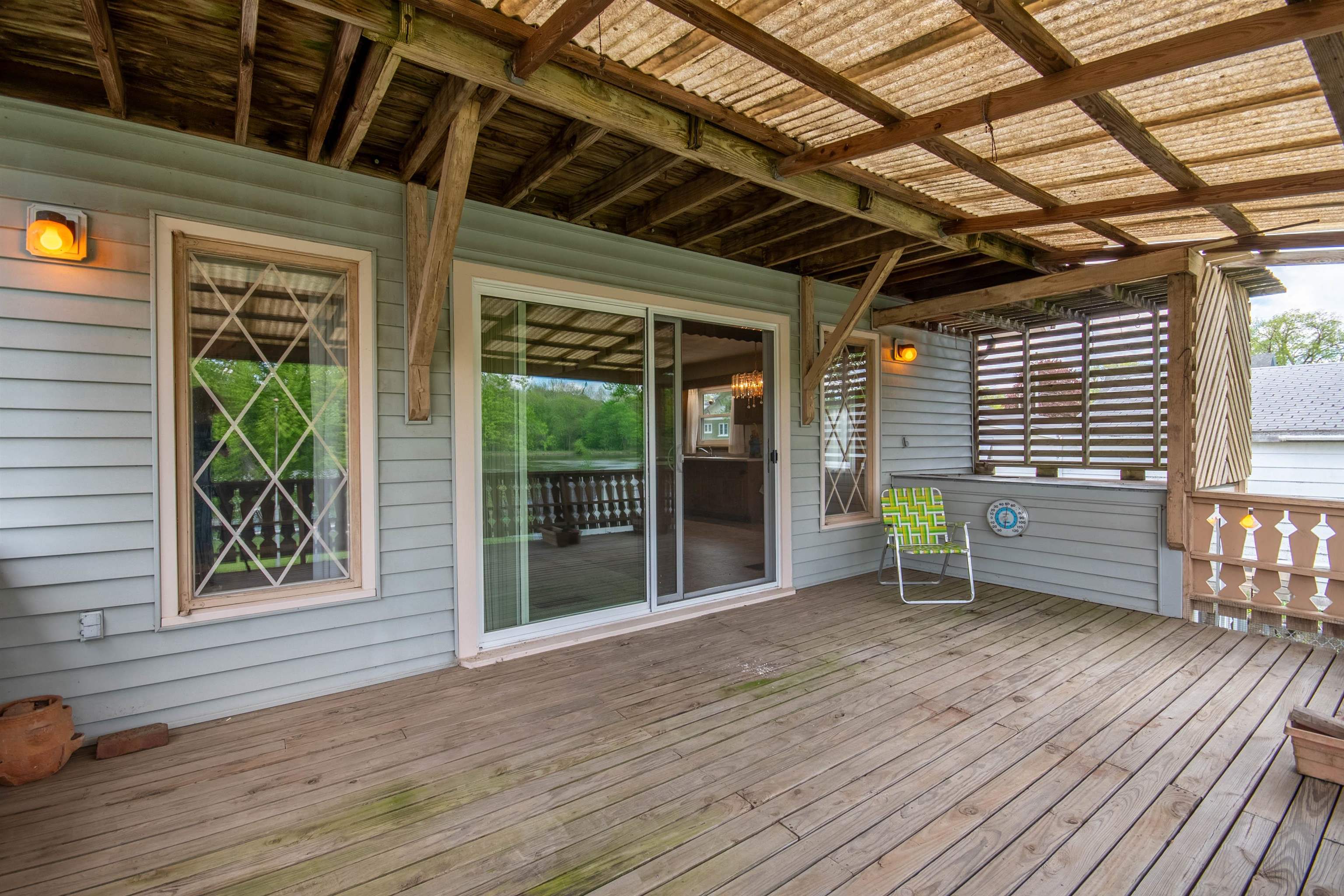1839 West 1st Street Dixon, IL 61021 - Photo 4 of 44 a porch area with wooden floors and outdoor seating