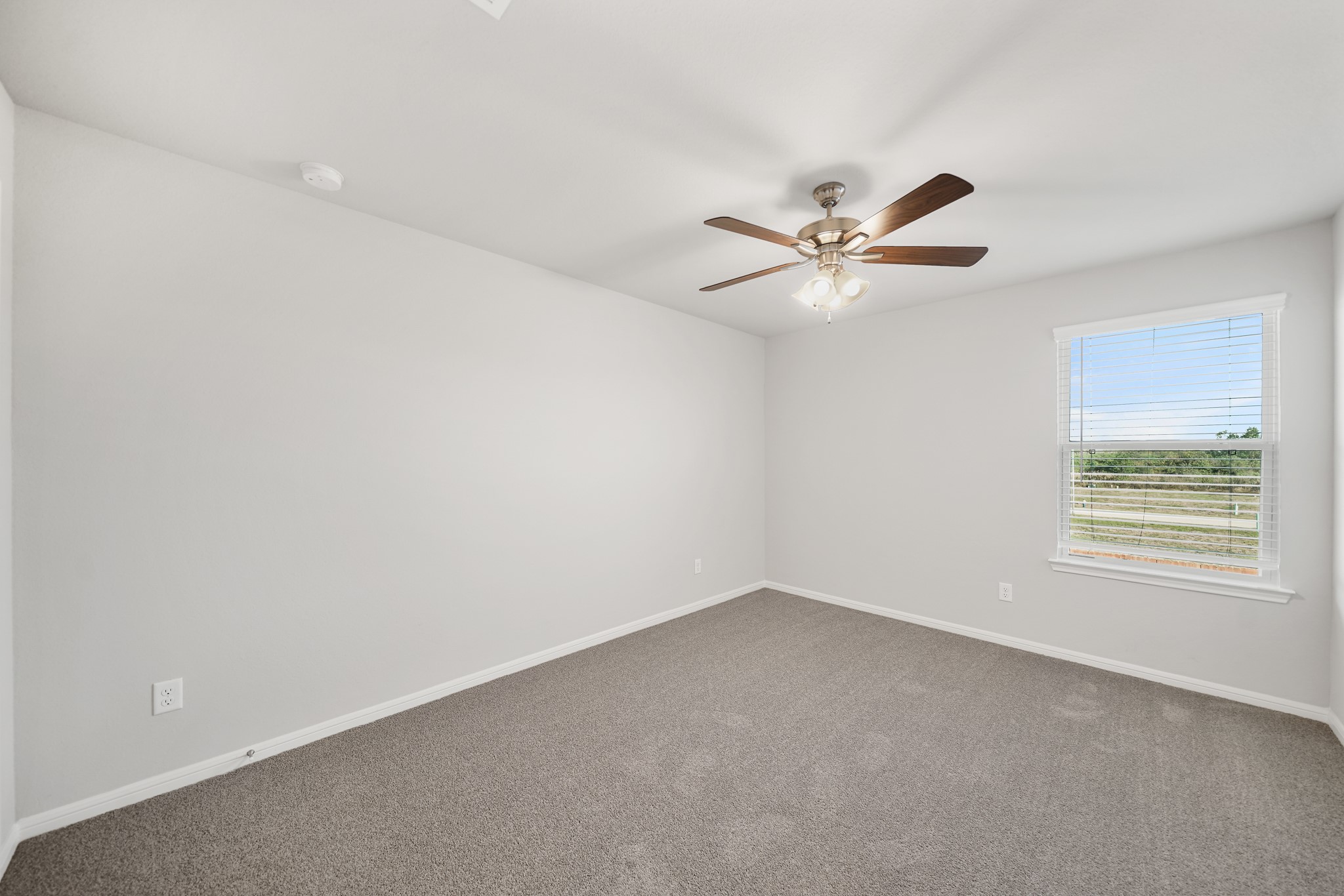 13309 Talisker Road Houston, TX 77048 - Photo 7 of 12 an empty room with a window and a ceiling fan