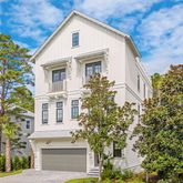 a view of a white house next to a tree