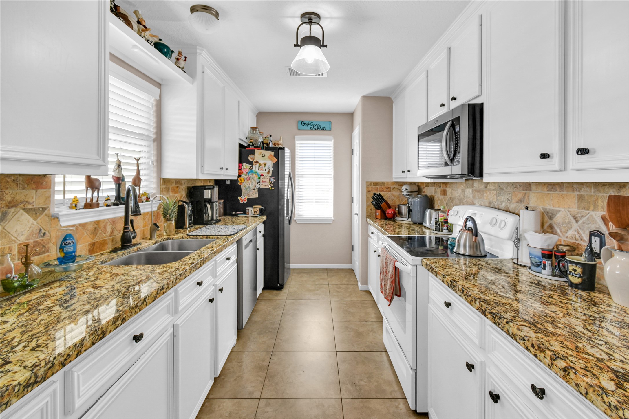 115 Driftwood Road Freeport, TX 77541 - Photo 12 of 21 a large kitchen with stainless steel appliances granite countertop a sink and cabinets