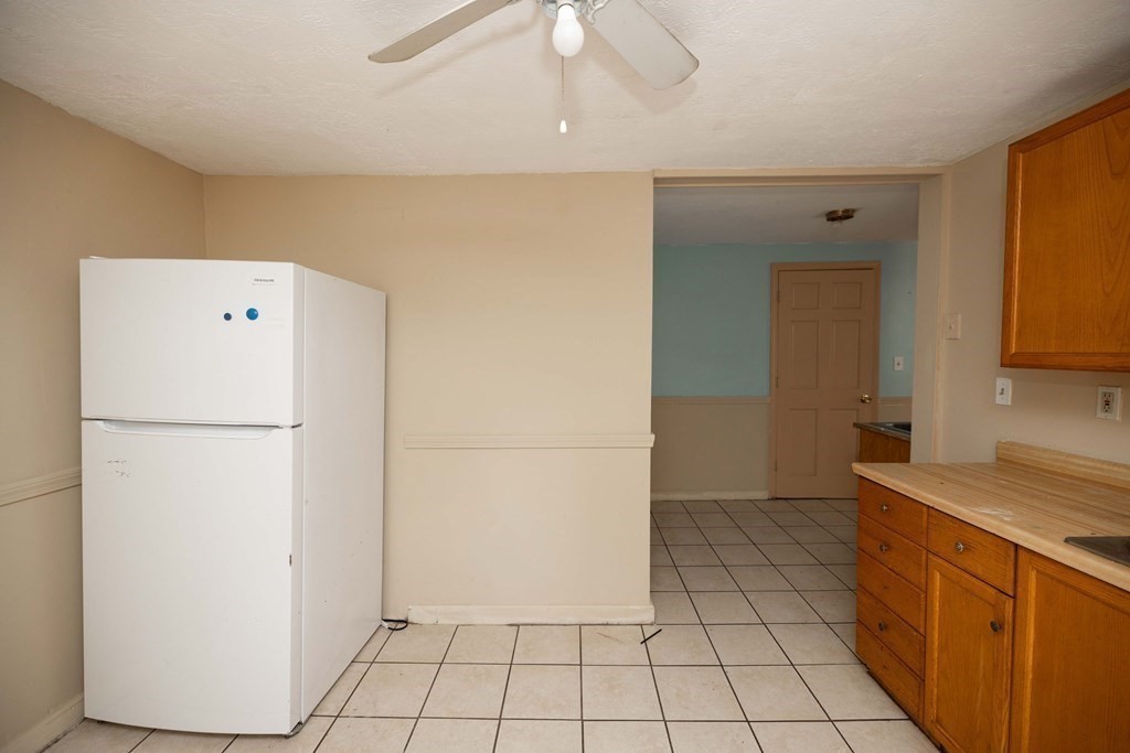 17 Montague Street, Unit B Worcester, MA 01603 - Photo 4 of 9 a utility room with cabinets washer and dryer
