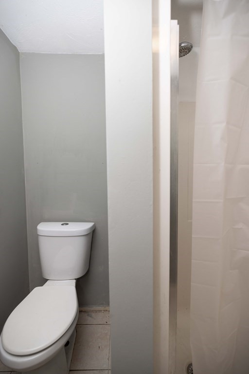 17 Montague Street, Unit B Worcester, MA 01603 - Photo 7 of 9 a white toilet sitting next to a white sink