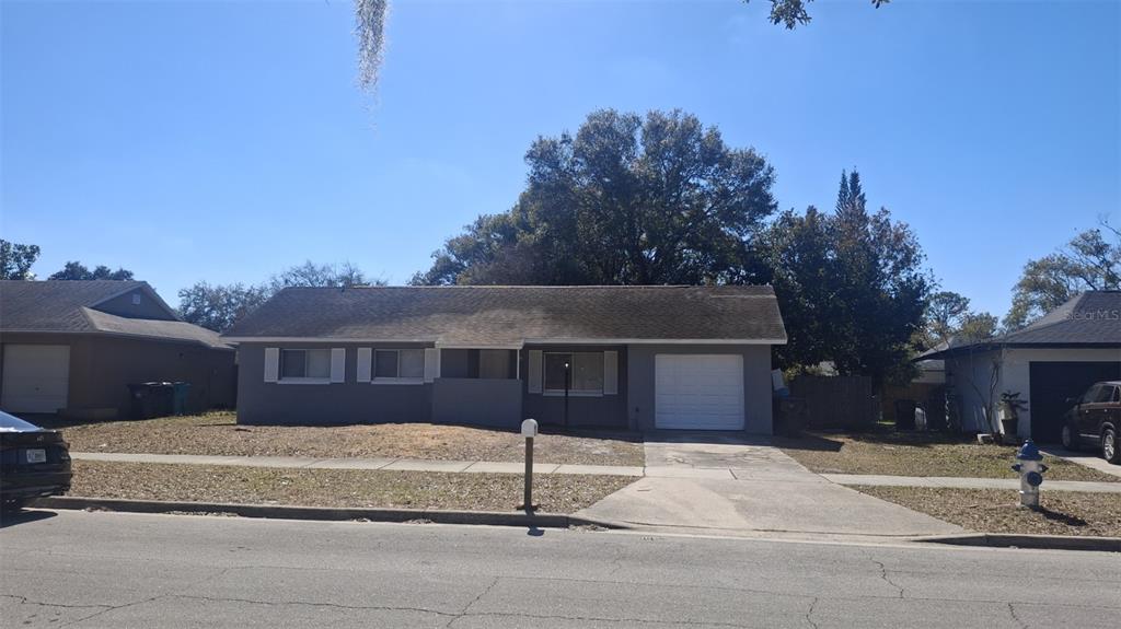 a front view of a house with a garden and garage