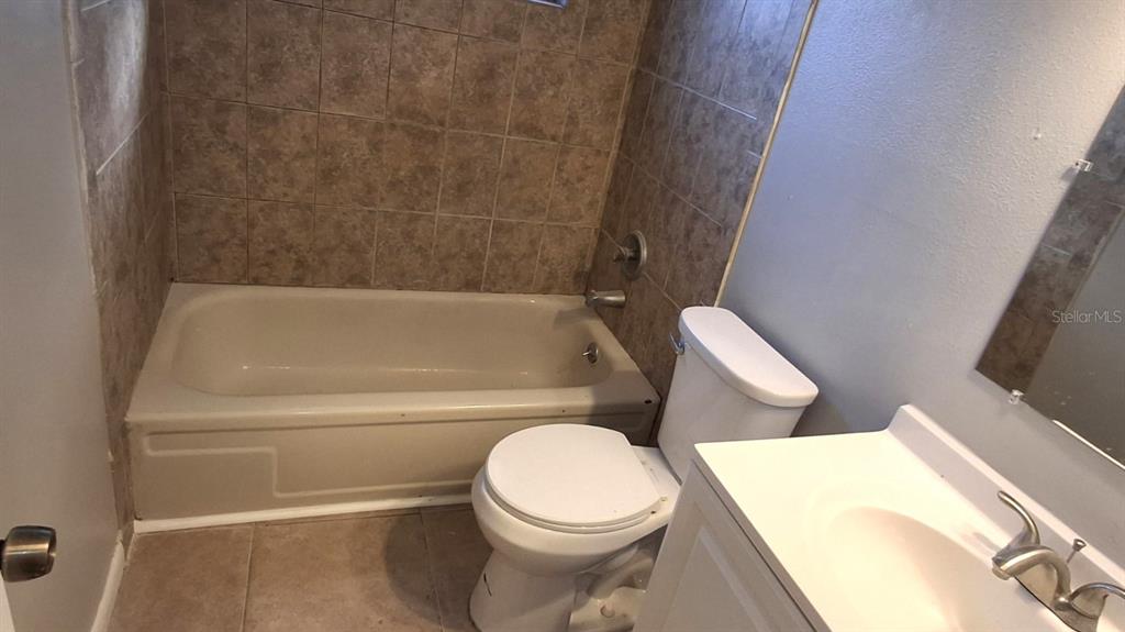 4720 Lighthouse Circle Orlando, FL 32808 - Photo 14 of 16 a white toilet sitting next to a bath tub