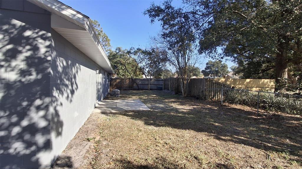 4720 Lighthouse Circle Orlando, FL 32808 - Photo 16 of 16 a view of a yard with plants and trees