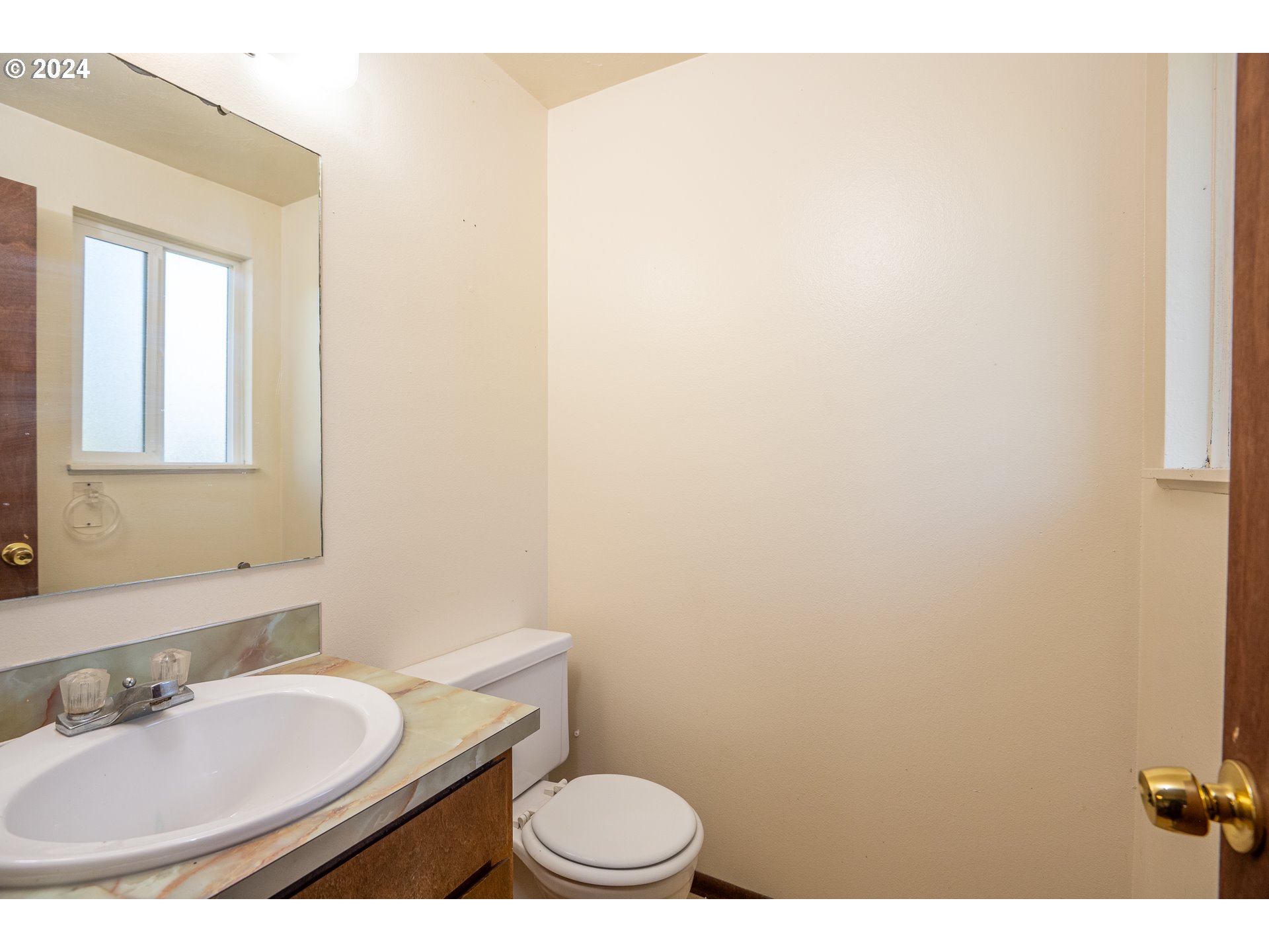 5124 E Street Springfield, OR 97478 - Photo 22 of 23 a bathroom with a granite countertop sink a mirror and a toilet