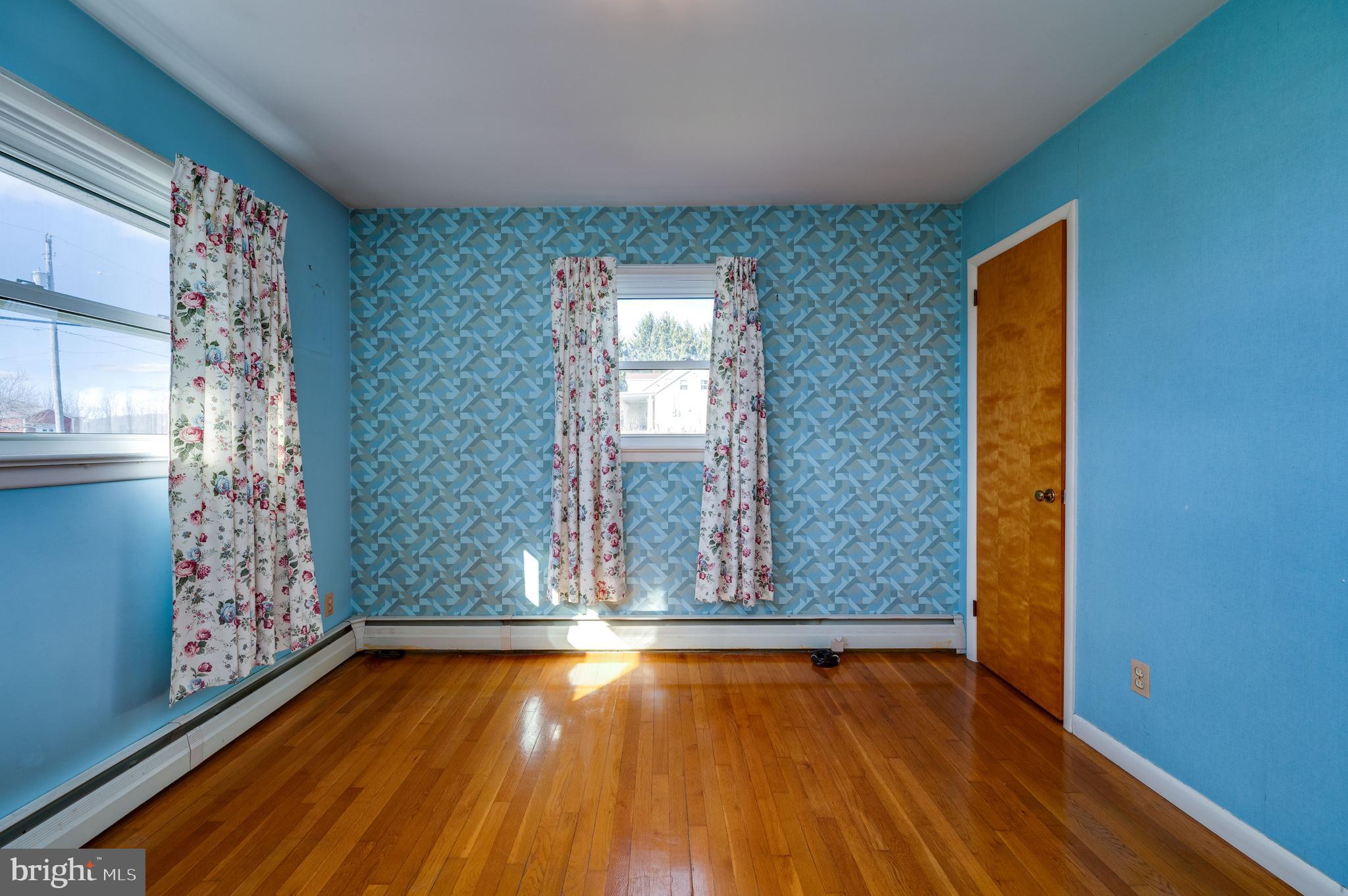 52 Crystal Cave Road Kutztown, PA 19530 - Photo 18 of 54 an empty room with wooden floor and windows