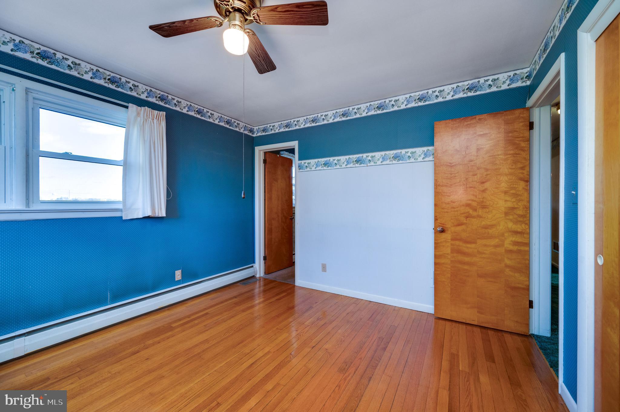 52 Crystal Cave Road Kutztown, PA 19530 - Photo 21 of 54 a view of empty room with wooden floor and fan