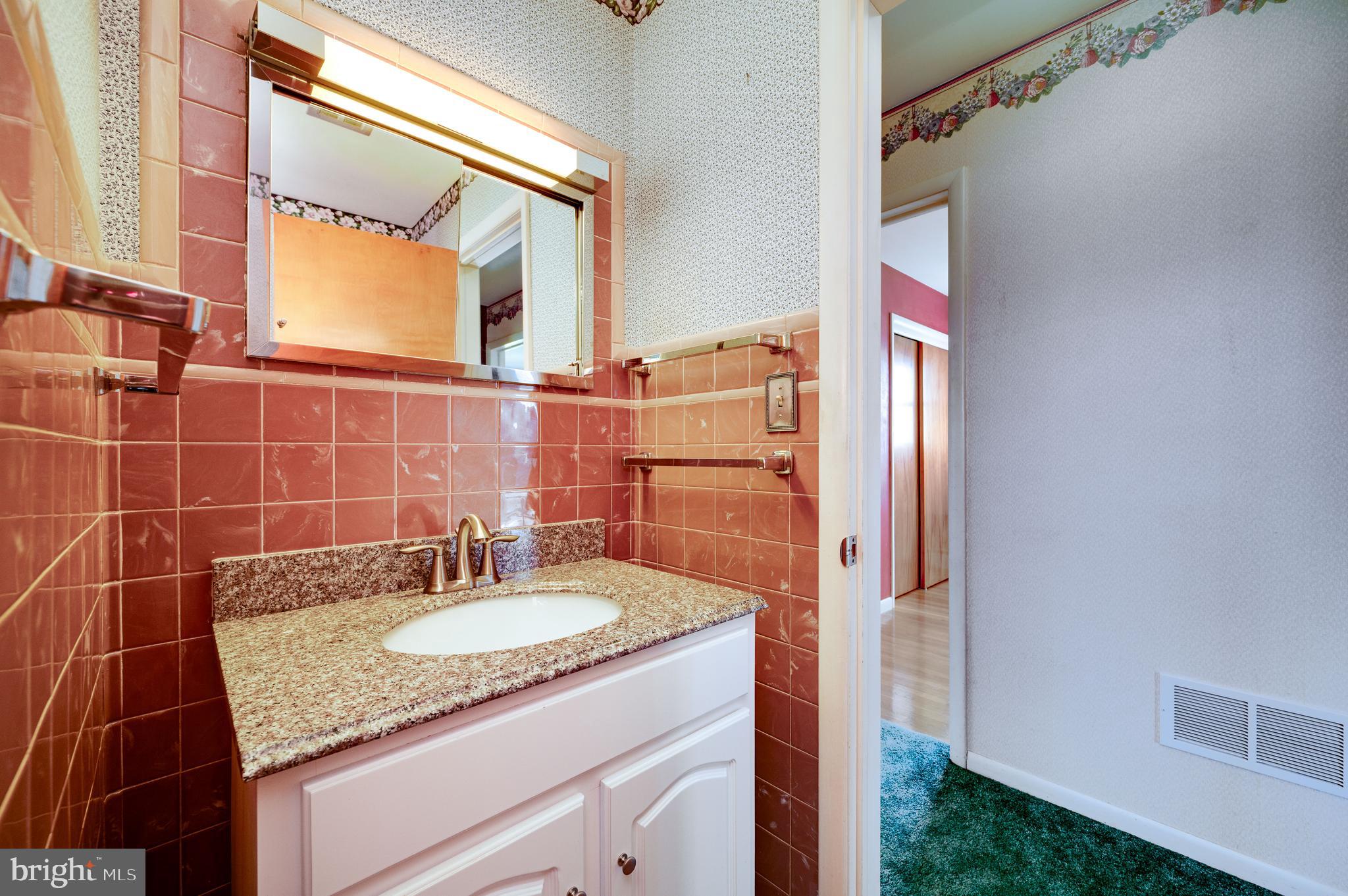 52 Crystal Cave Road Kutztown, PA 19530 - Photo 23 of 54 a bathroom with a granite countertop sink and a mirror