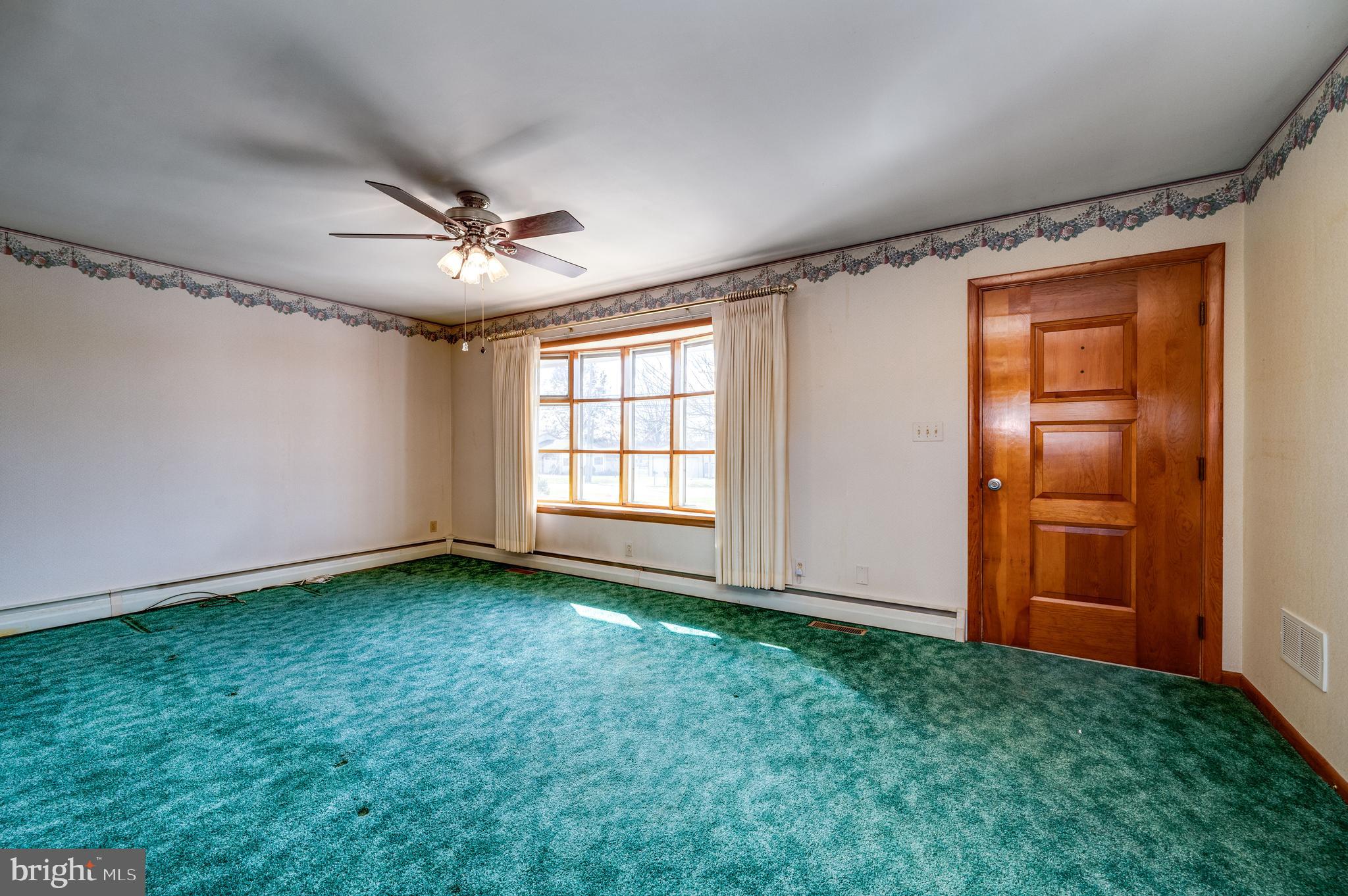 52 Crystal Cave Road Kutztown, PA 19530 - Photo 3 of 54 a view of an empty room with window and chandelier fan