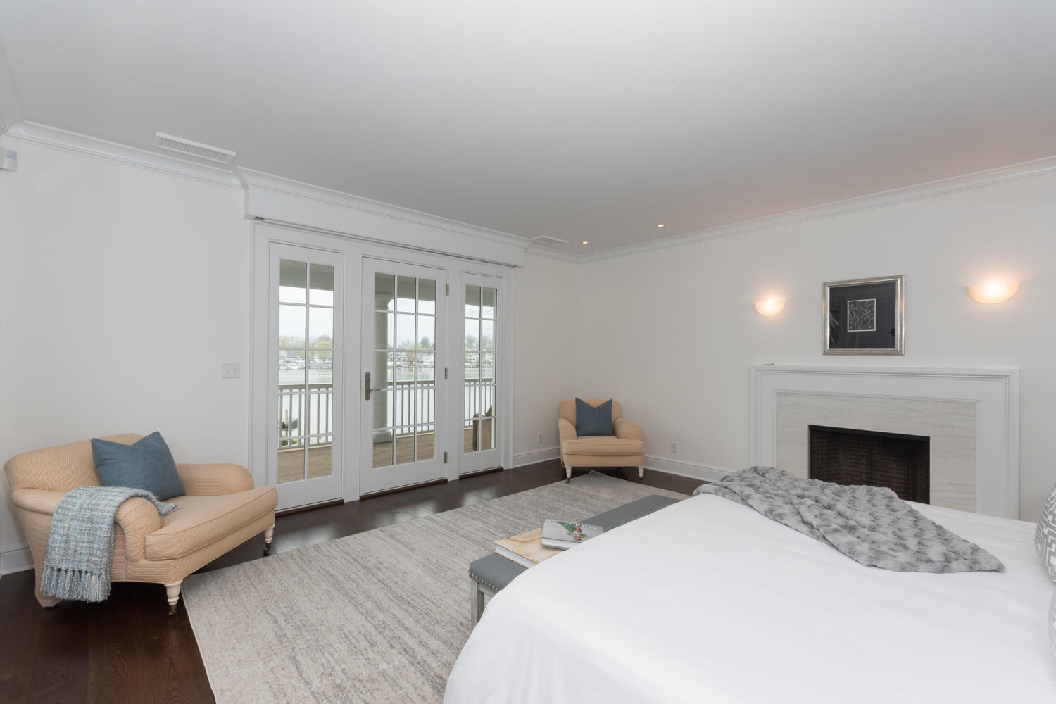 112 5 Mile River Road Darien, CT 06820 - Photo 13 of 34 a spacious bedroom with a balcony a bed and a couch