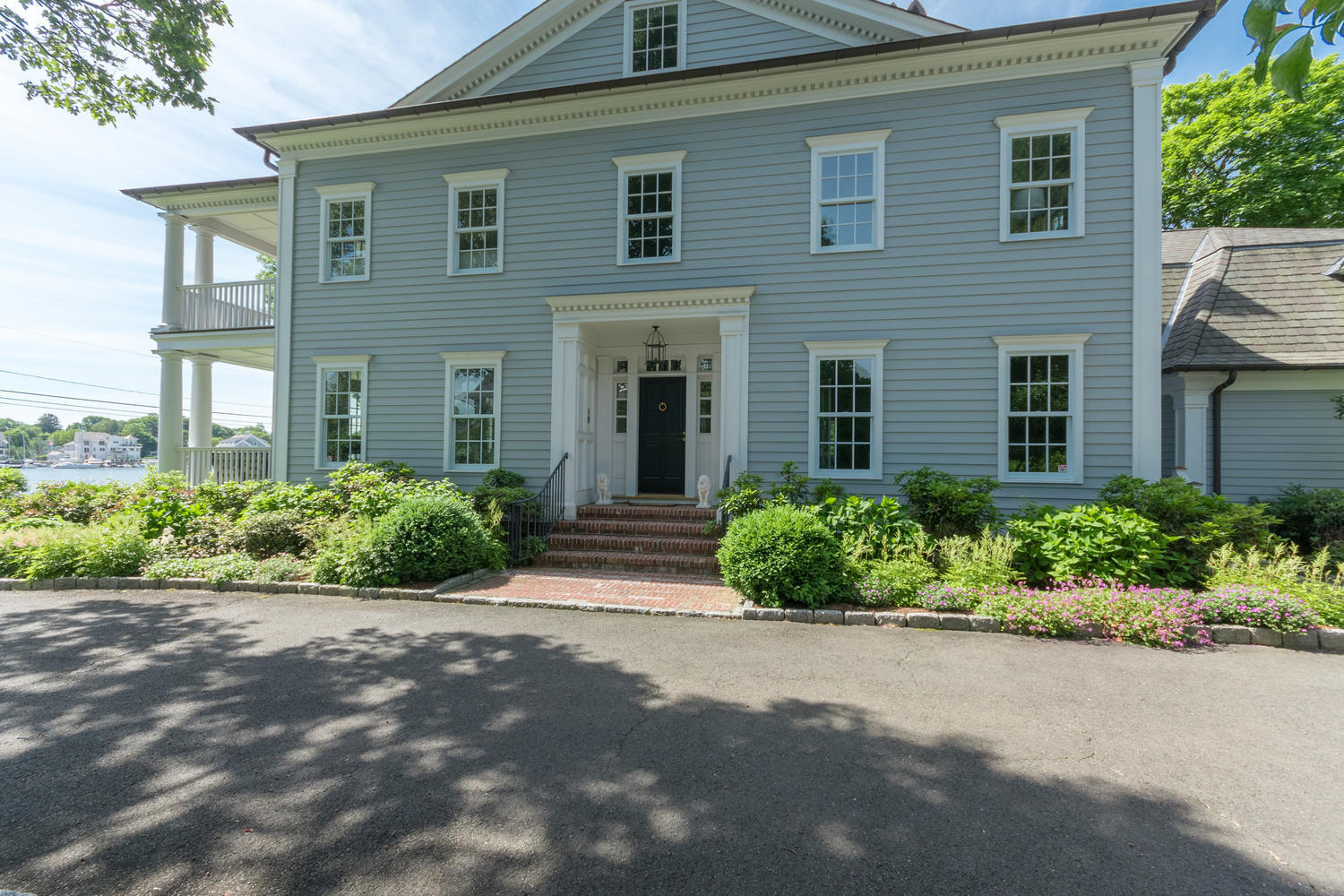 112 5 Mile River Road Darien, CT 06820 - Photo 28 of 34 a front view of a house with a garden