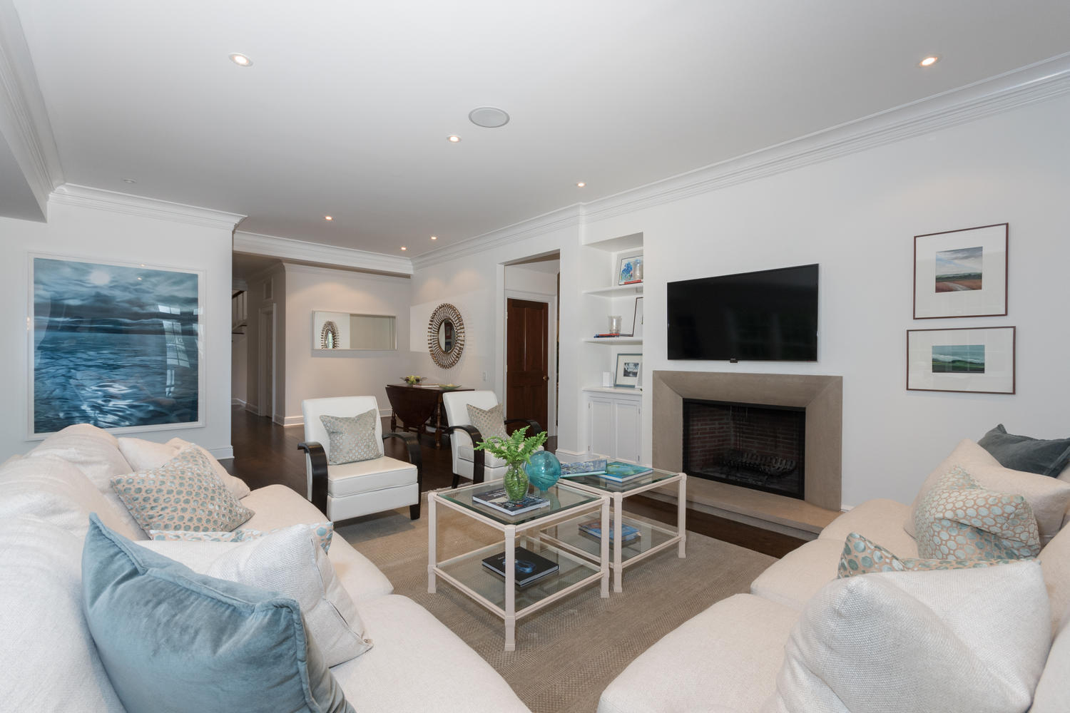 112 5 Mile River Road Darien, CT 06820 - Photo 5 of 34 a living room with furniture a flat screen tv and a fireplace