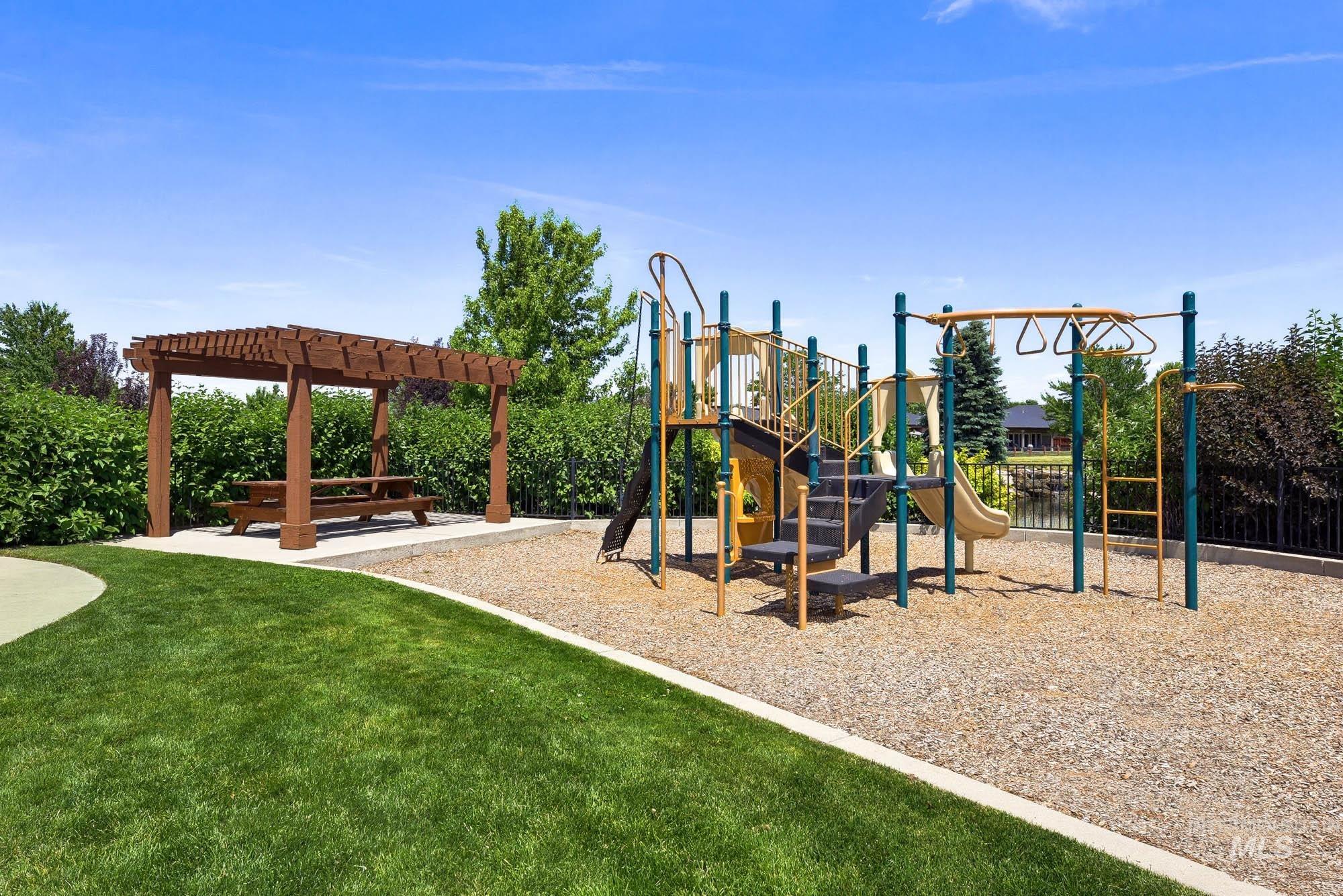 220 South Wildgrass Way Star, ID 83669 - Photo 49 of 50 Outdoor recreation area featuring a multi-level playground structure with slides and monkey bars, a wood pergola, and a picnic table