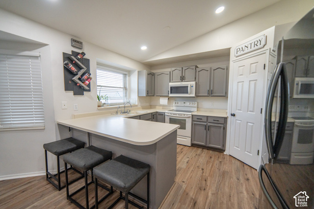 7676 Jefferson Road Magna, UT 84044 - Photo 4 of 24 Kitchen featuring wood-finish flooring, recessed lighting, light-toned countertops, and gray cabinetry