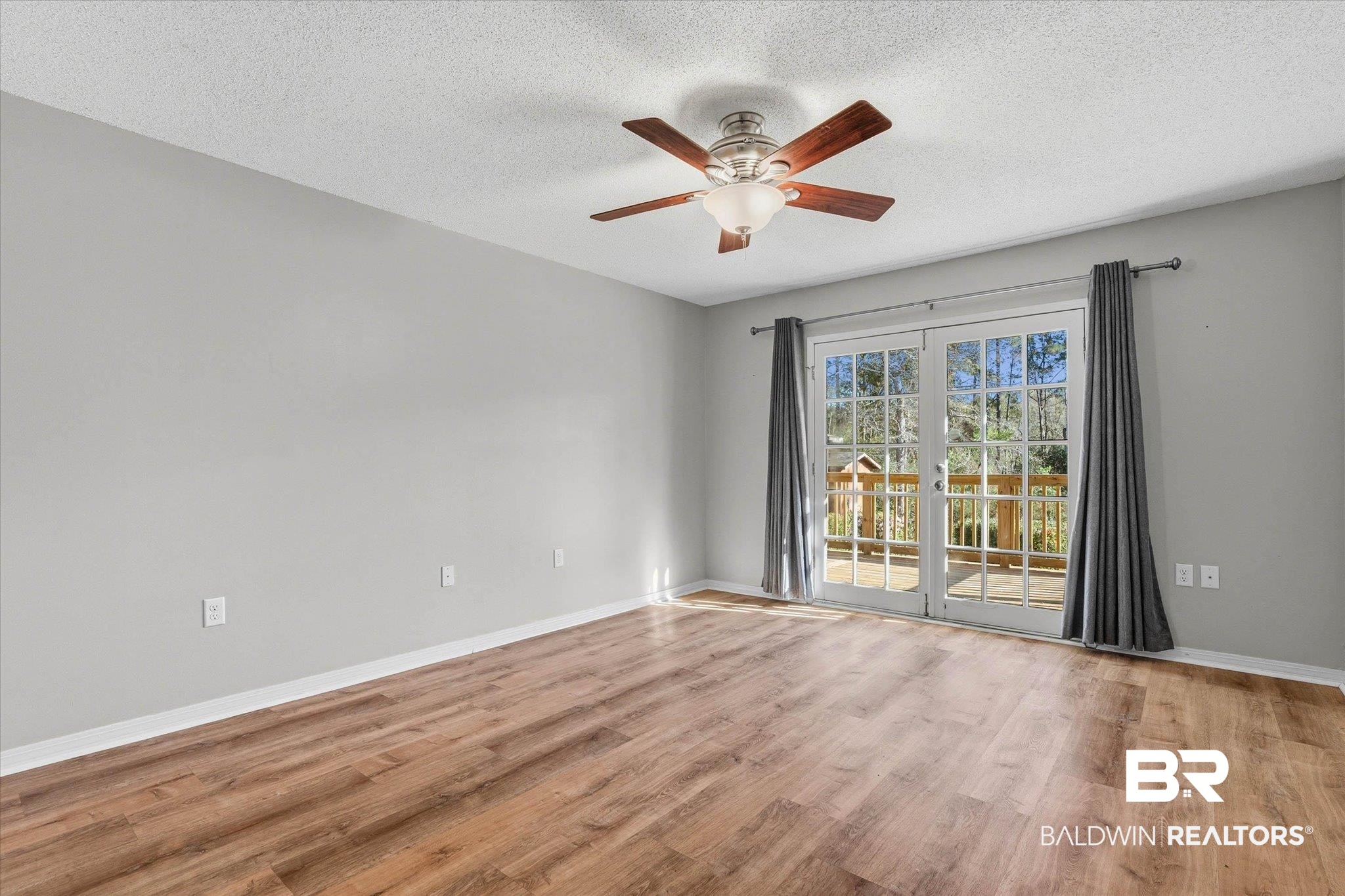 8030 Country Drive Mobile, AL 36619 - Photo 9 of 22 Unfurnished room featuring light wood-style floors, ceiling fan, and a textured ceiling