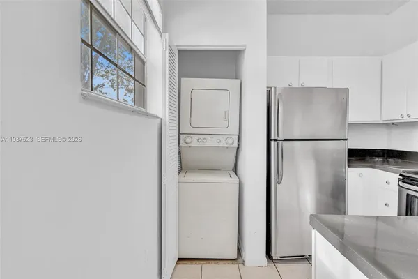 a kitchen with granite countertop white cabinets and white appliances