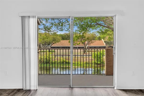 a view of an empty room with wooden floor