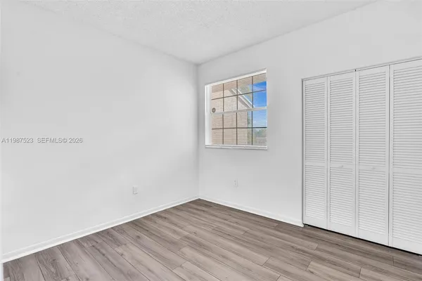 a bedroom with a large bed and a flat screen tv