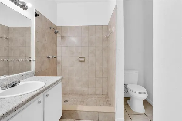 a kitchen with granite countertop a sink stove and refrigerator