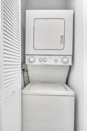 an aerial view of a house with a yard and lake view