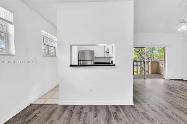 a kitchen with stainless steel appliances granite countertop a refrigerator a stove and a sink