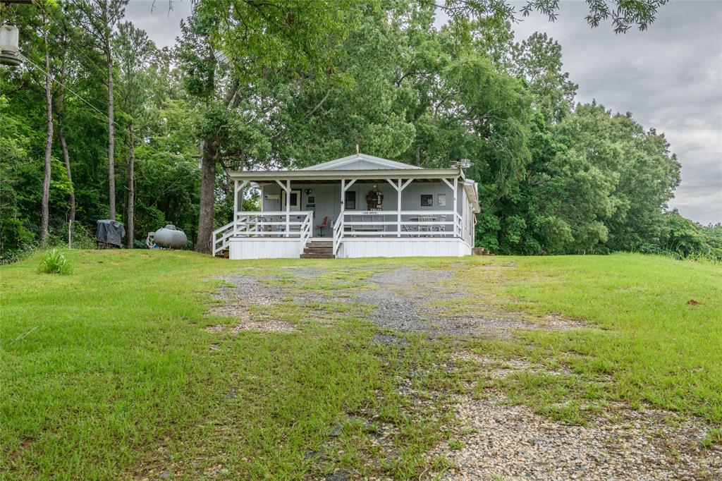 122 Grice Road Ringgold, LA 71068 - Photo 20 of 26 Ranch-style residence featuring a covered front porch with white railing, light gray siding, and a white trim