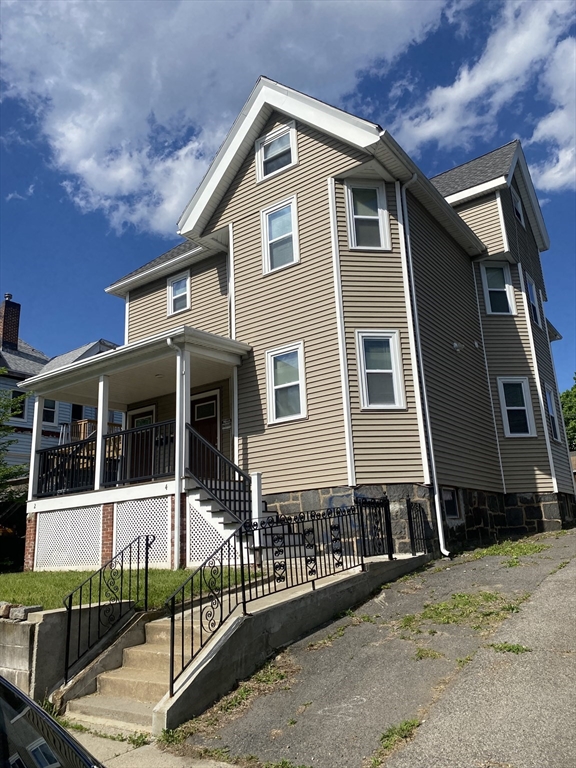 4 Hopestill Street, Unit 1 Boston, MA 02124 - Photo 2 of 5 a front view of a house with a wooden fence