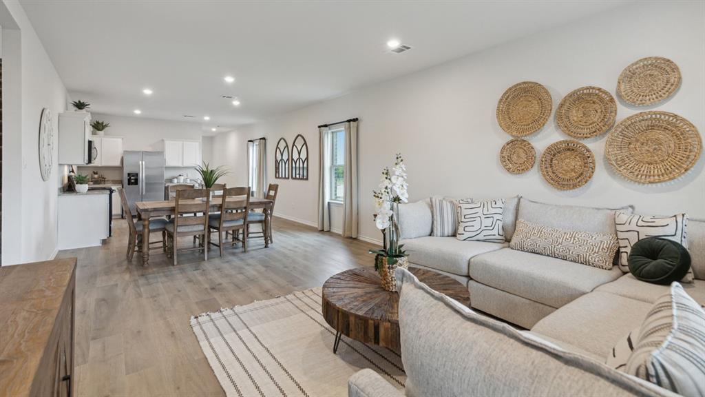 140 Pheasant Run Road Terrell, TX 75160 - Photo 9 of 26 Open-concept living space featuring wood-finish flooring, recessed lighting, and ample natural light from multiple windows