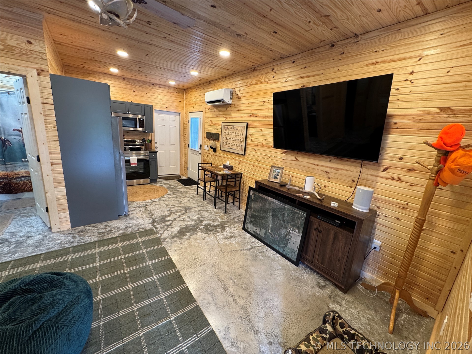 20862 East 1160th Road Keota, OK 74941 - Photo 18 of 47 Open-concept living space with wood-paneled walls and ceiling