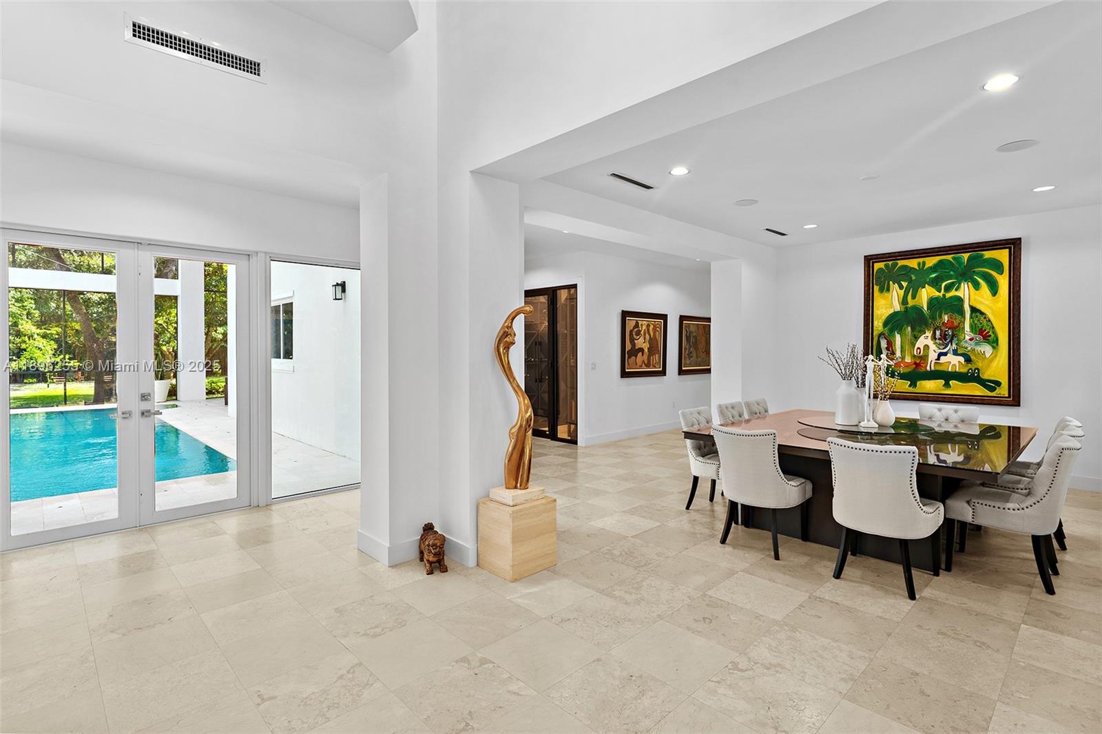 8923 Ludlam Road Pinecrest, FL 33156 - Photo 12 of 69 a living room with furniture a rug and a floor to ceiling window