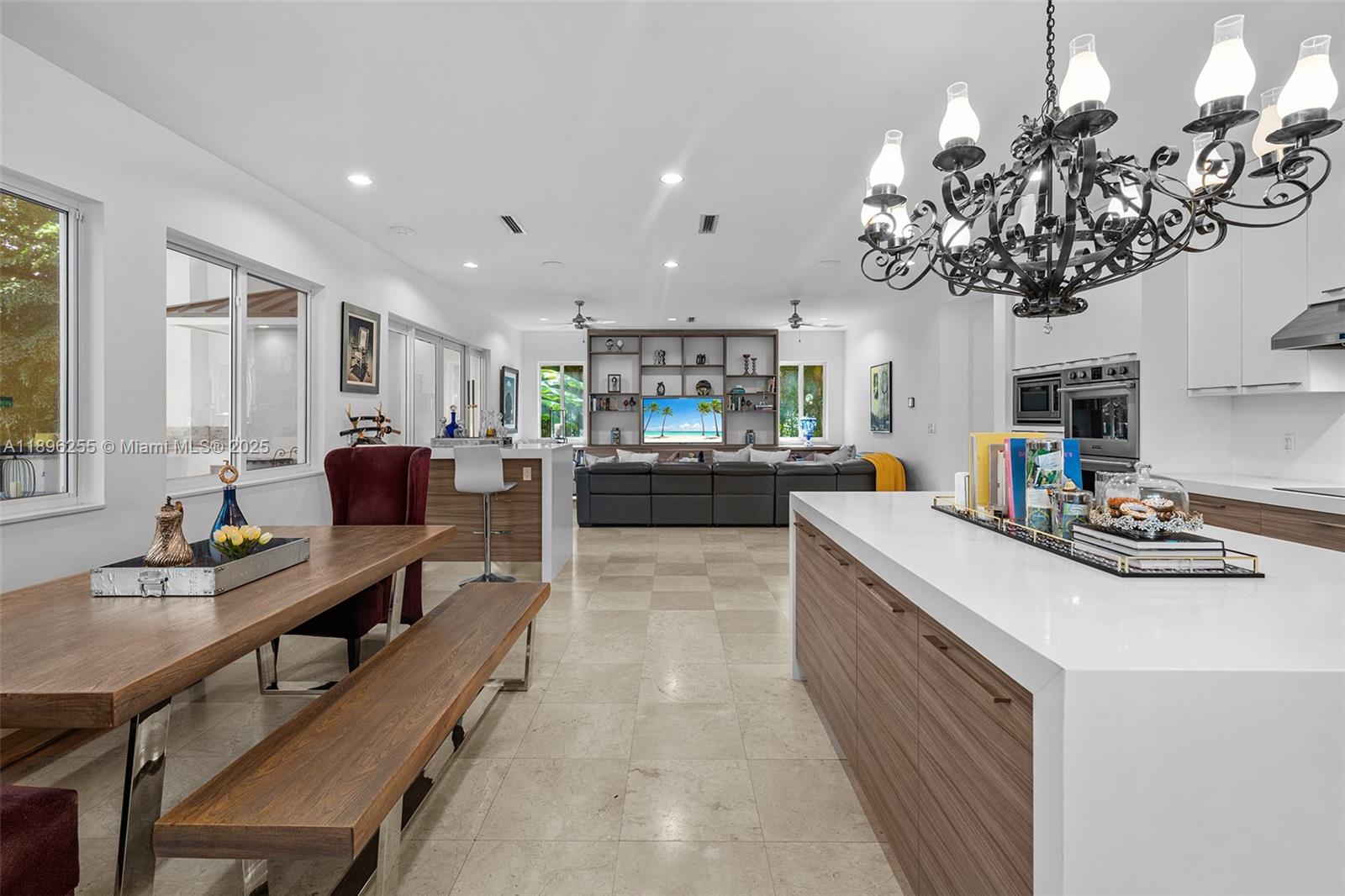 8923 Ludlam Road Pinecrest, FL 33156 - Photo 17 of 69 a kitchen with a sink appliances and a dining table