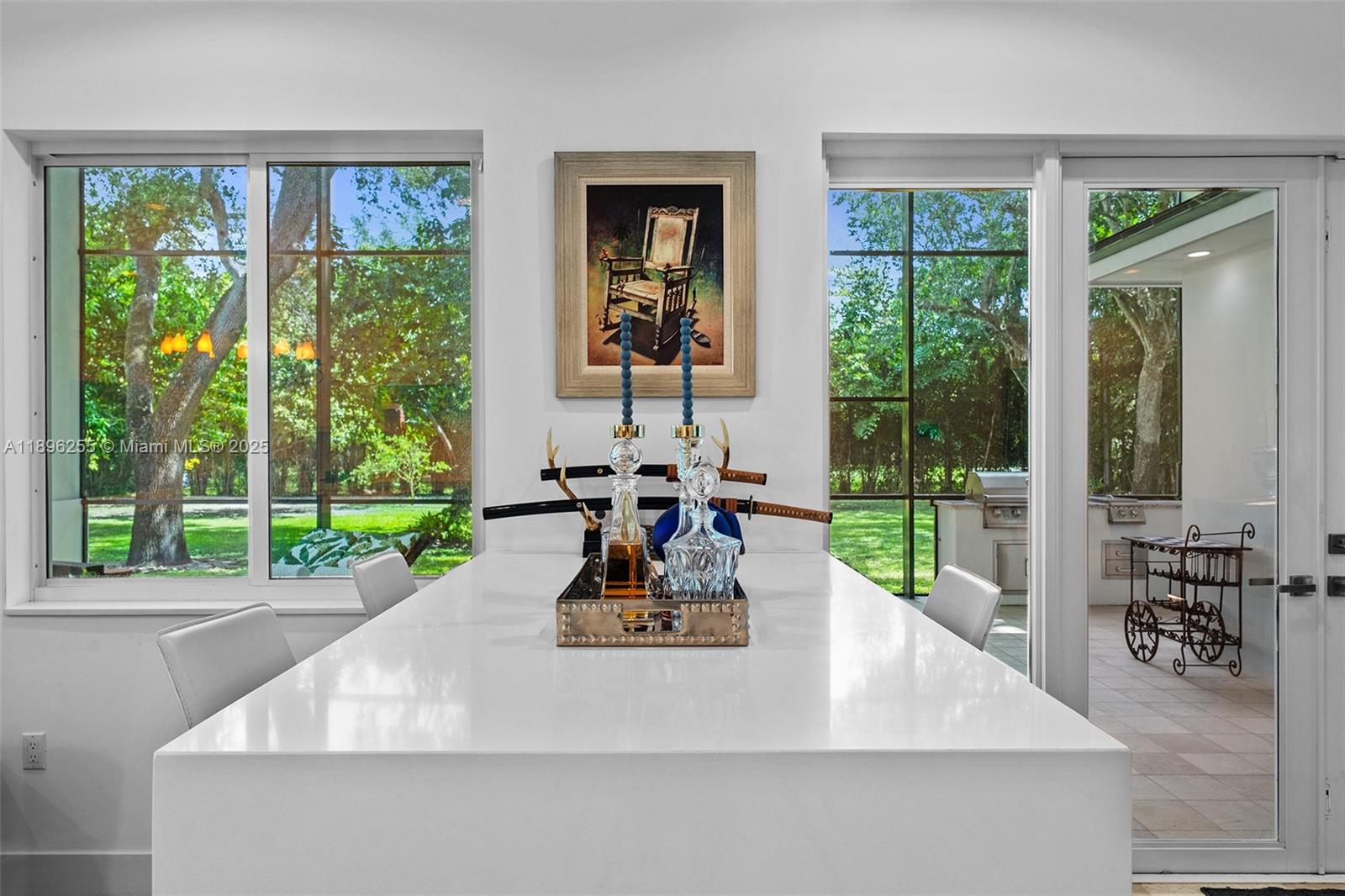 8923 Ludlam Road Pinecrest, FL 33156 - Photo 18 of 69 a view of a living room and porch with a floor to ceiling window