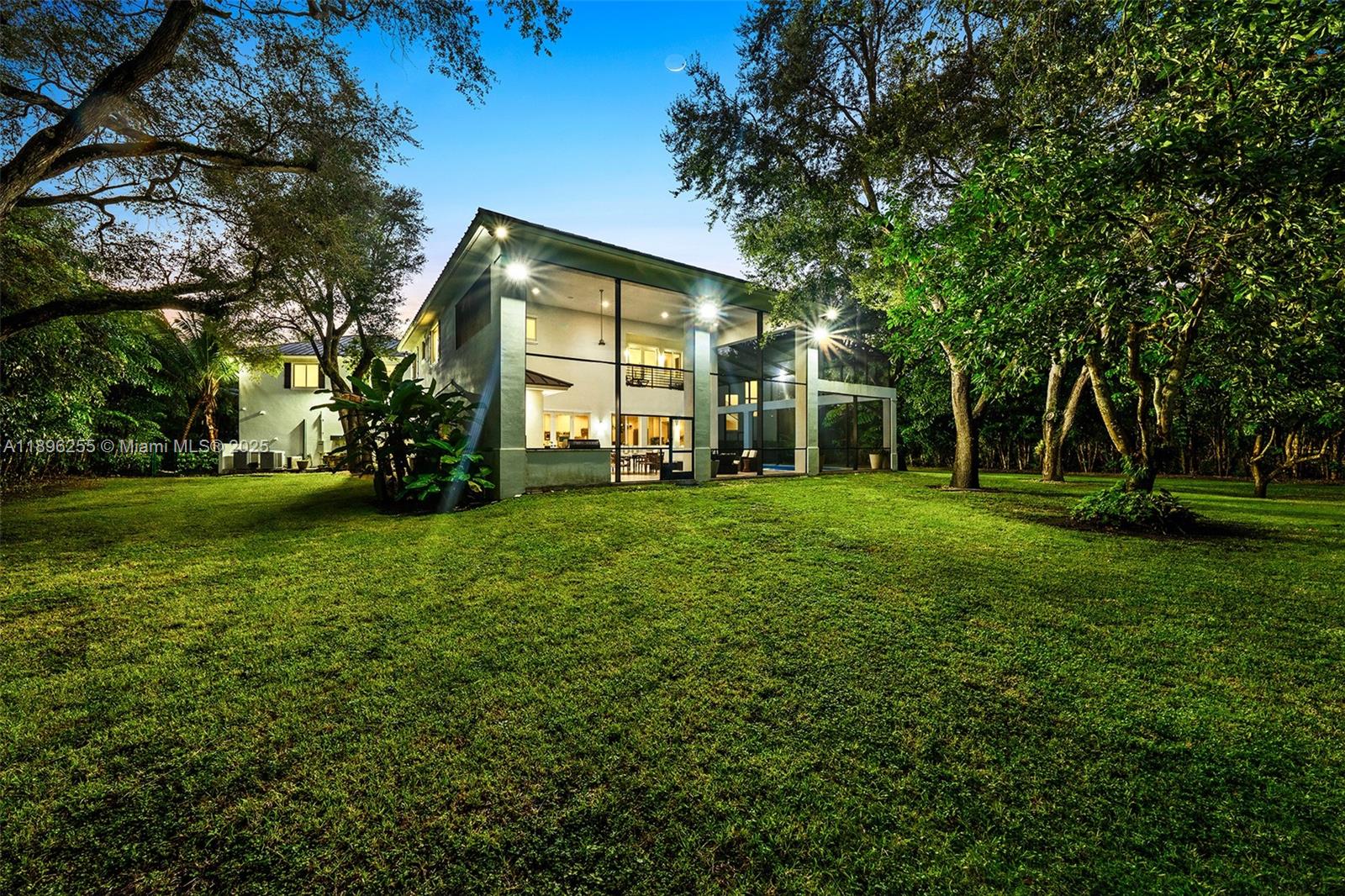 8923 Ludlam Road Pinecrest, FL 33156 - Photo 29 of 69 a front view of a house with a yard