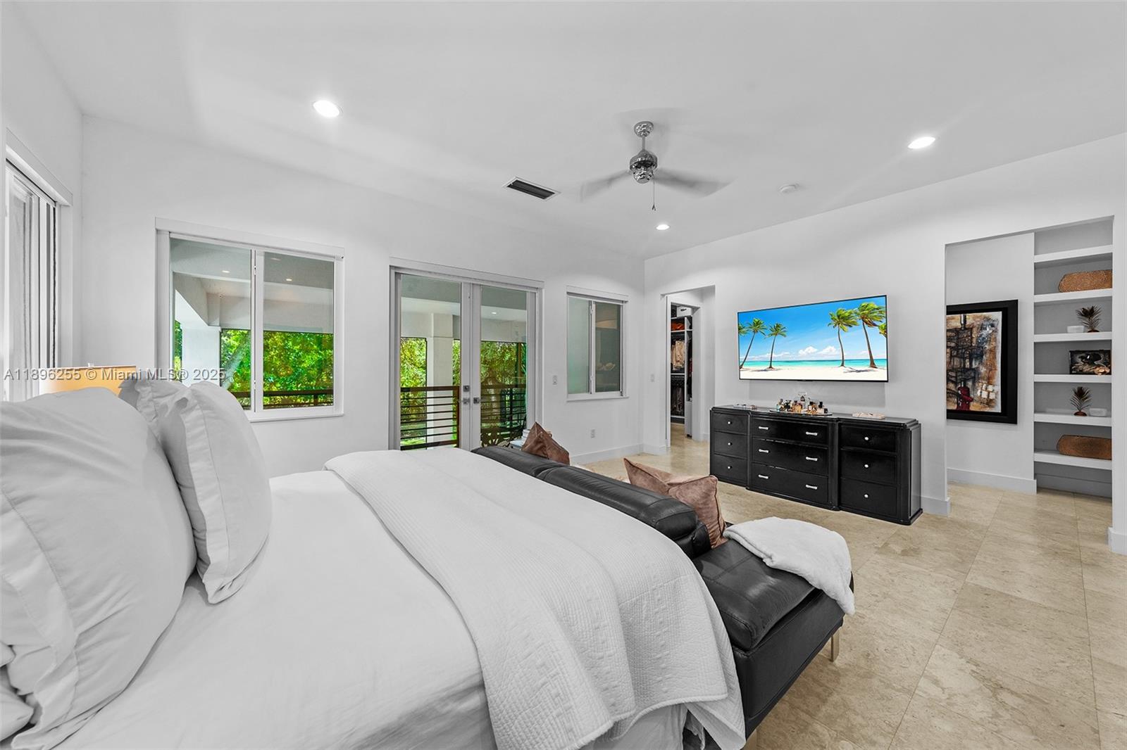 8923 Ludlam Road Pinecrest, FL 33156 - Photo 31 of 69 a spacious bedroom with a large bed and a window