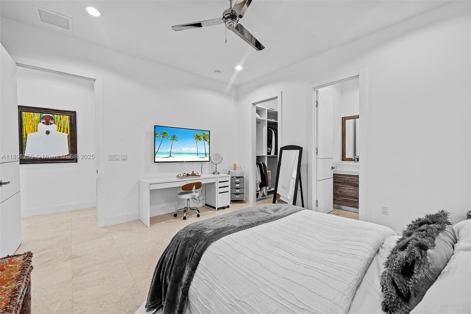 8923 Ludlam Road Pinecrest, FL 33156 - Photo 40 of 69 a bedroom with a bed next to a window and a flat screen tv