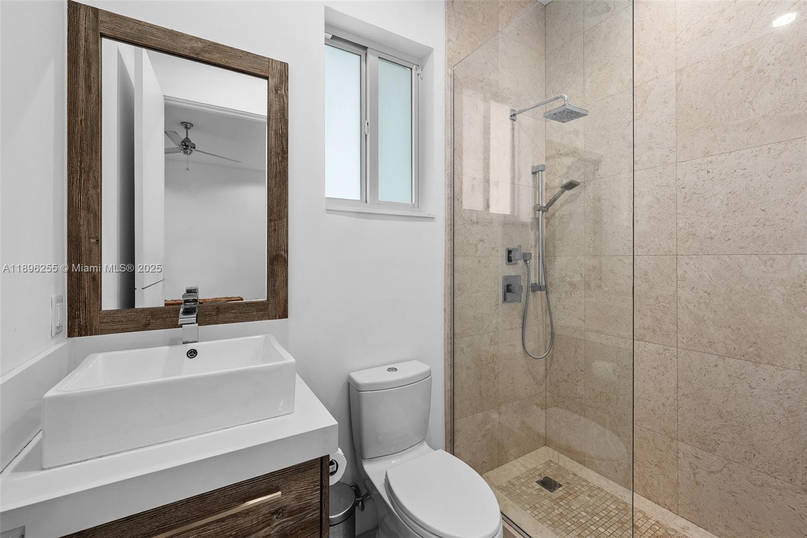 8923 Ludlam Road Pinecrest, FL 33156 - Photo 42 of 69 a bathroom with a sink a toilet and shower