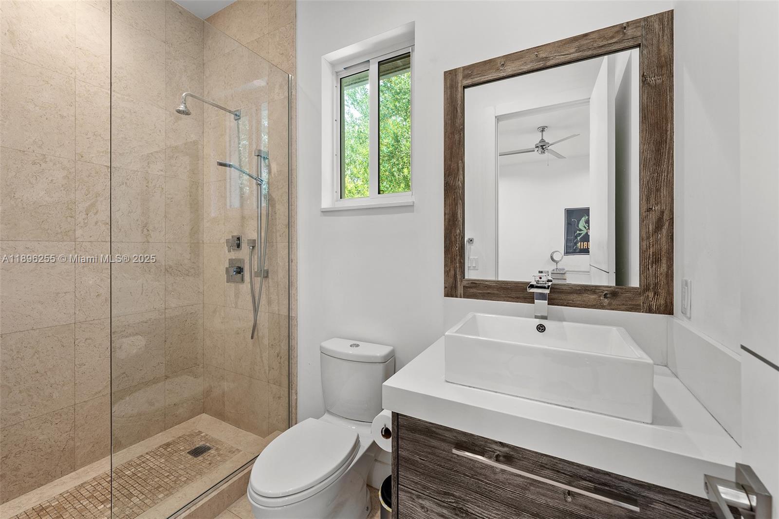 8923 Ludlam Road Pinecrest, FL 33156 - Photo 45 of 69 a bathroom with a sink a toilet and shower