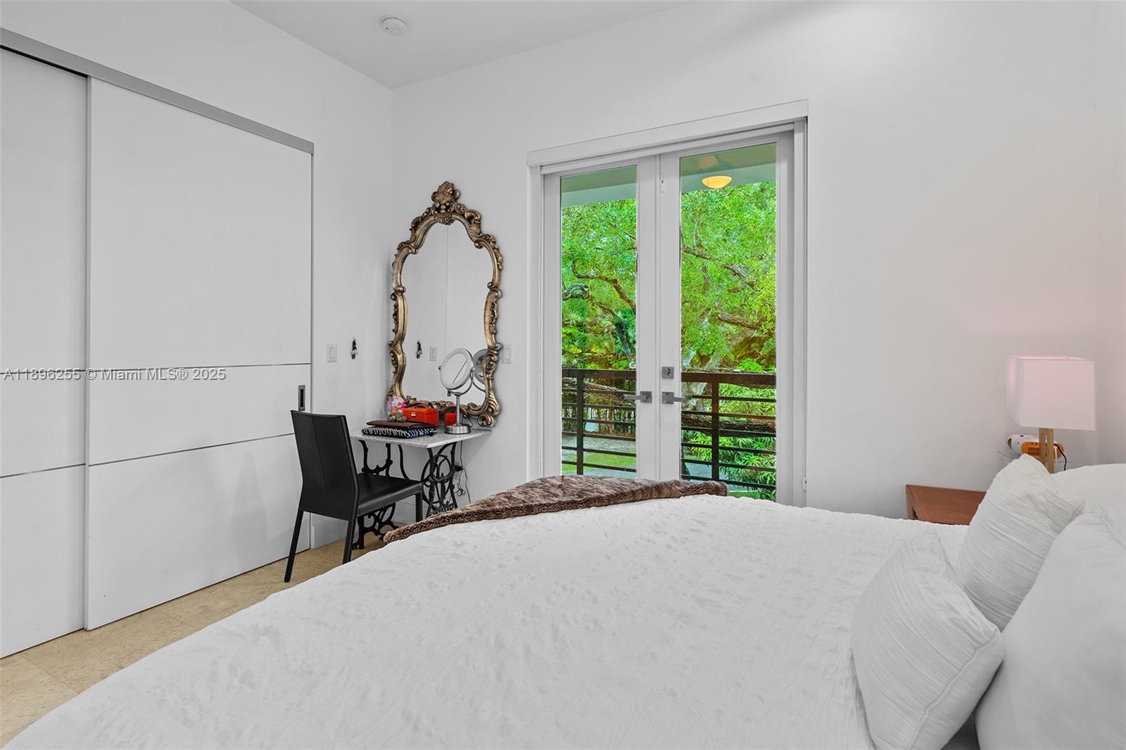 8923 Ludlam Road Pinecrest, FL 33156 - Photo 54 of 69 a bed room with a bed and a chair